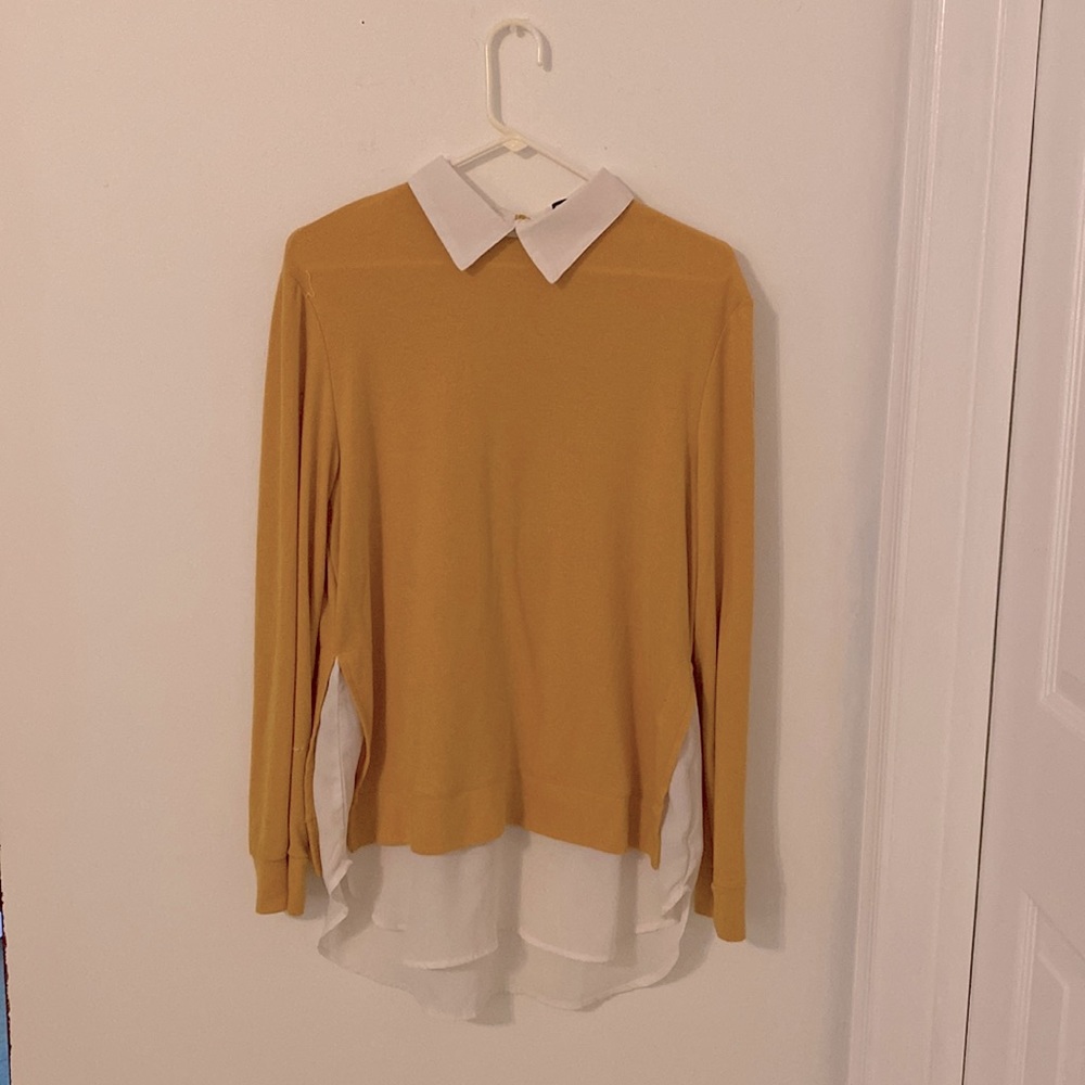 Yellow long sleeved shirt.